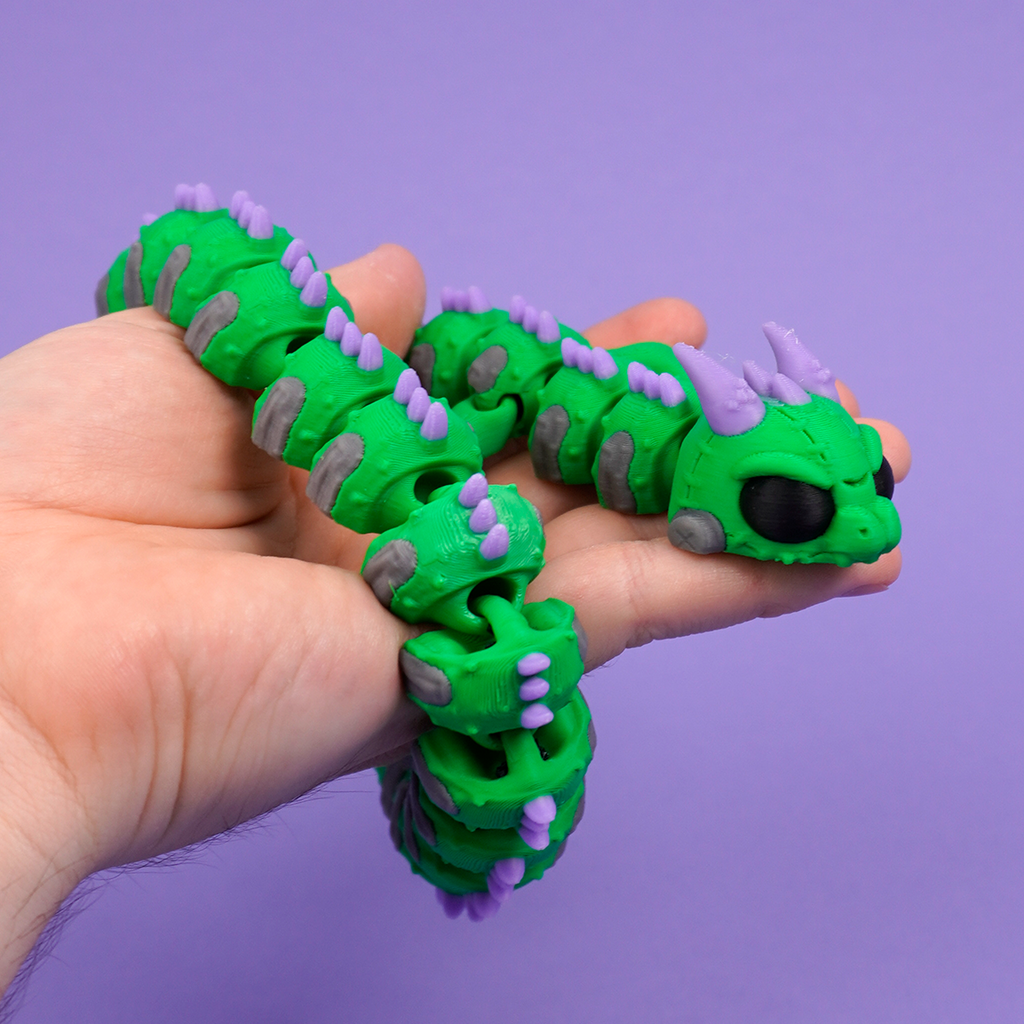 Articulated Frankenstein Dragon stretched out on purple background